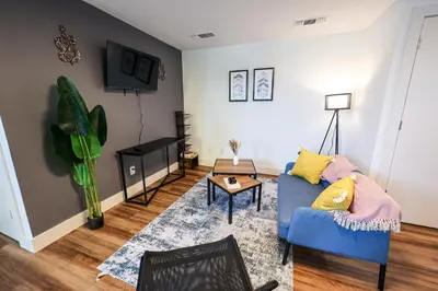 a living room with a blue couch and a table at Studio Apartment in the Heart of Philadelphia in Philadelphia