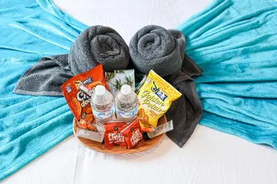 a basket with bottled water and towels on a bed at Studio Apartment in the Heart of Philadelphia in Philadelphia