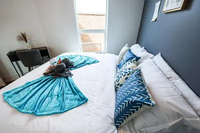 a bed with a stuffed animal sitting on top of it at Studio Apartment in the Heart of Philadelphia in Philadelphia