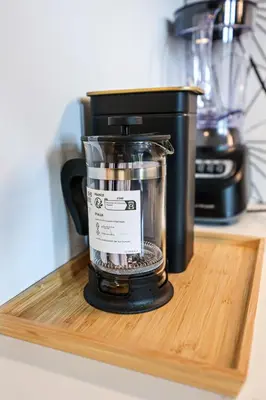 a black blender sitting on a wooden cutting board at Studio Apartment in the Heart of Philadelphia in Philadelphia