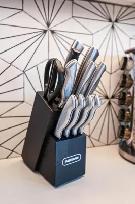 a black knife block with utensils in it at Studio Apartment in the Heart of Philadelphia in Philadelphia