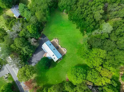 an aerial view of a house in the middle of a forest at Nature Getaway Charming Villa Near Trails & Parks in Monroe