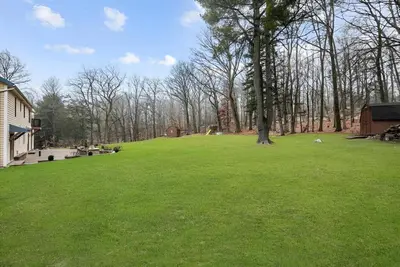 a large green field with a tree in the middle at Nature Getaway Charming Villa Near Trails & Parks in Monroe