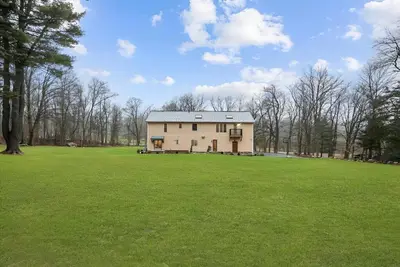 a large grassy field with a large house at Nature Getaway Charming Villa Near Trails & Parks in Monroe