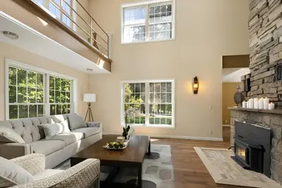 a living room with a couch and a fireplace at Nature Getaway Charming Villa Near Trails & Parks in Monroe
