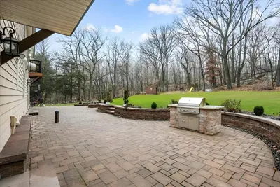 a brick patio with a grill in a yard at Nature Getaway Charming Villa Near Trails & Parks in Monroe