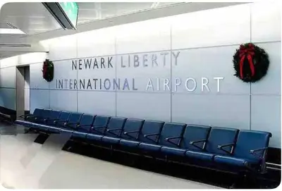 a row of blue seats in a newark library international airport at The Orange Oasis in Bayonne