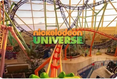 a roller coaster in a mall with a sign that reads nickelodeon universe at The Orange Oasis in Bayonne