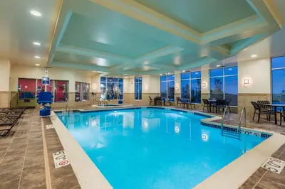 a large pool with blue water in a hotel room at Hilton Garden Inn Wayne in Wayne
