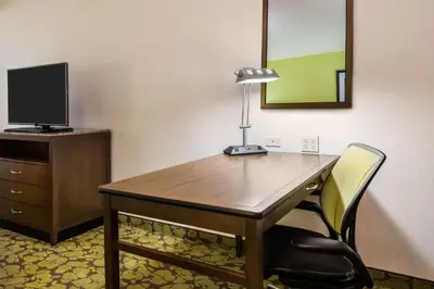 a desk with a lamp and a chair in a room at Hilton Garden Inn Wayne in Wayne