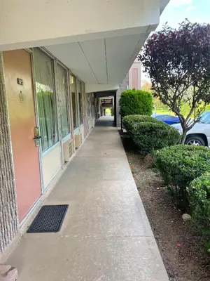a building with a walkway in front of a building at Travelers Inn in South Brunswick Terrace