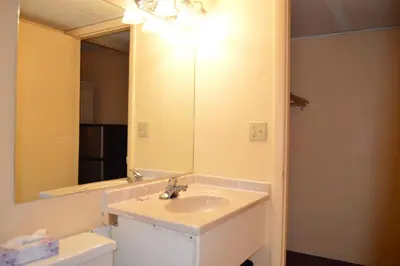 a bathroom with a sink and a mirror at Travelers Inn in South Brunswick Terrace