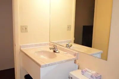a bathroom with a sink and a mirror at Travelers Inn in South Brunswick Terrace