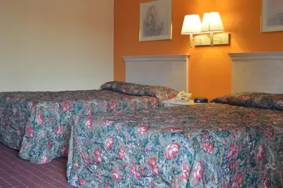 a hotel room with two beds and a telephone at Travelers Inn in South Brunswick Terrace