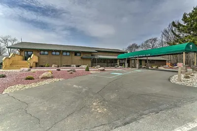 an empty parking lot in front of a building at Private Hot Tub and Game Room Pocono Family Cabin! in Tobyhanna