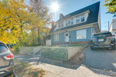 a house with a car parked in front of it at 1 Mi to Train Station Quiet Apartment in Newark in Newark