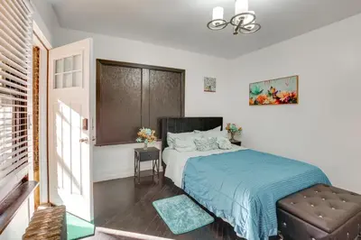 a bedroom with a bed with a blue blanket at 1 Mi to Train Station Quiet Apartment in Newark in Newark