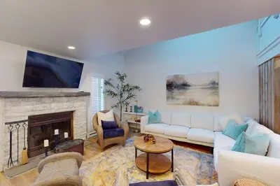 a living room with a couch and a fireplace at 103 Ruffed Grouse Ct in Lake Harmony