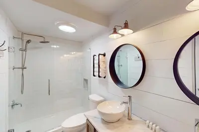 a white bathroom with a sink and a mirror at 103 Ruffed Grouse Ct in Lake Harmony