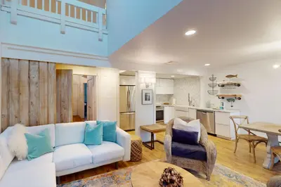 a living room with a white couch and a table at 103 Ruffed Grouse Ct in Lake Harmony