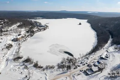an aerial view of a lake in the snow at 103 Ruffed Grouse Ct in Lake Harmony