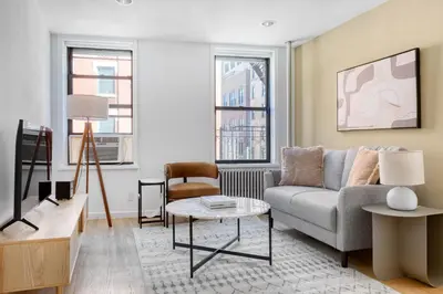 a living room with a couch and a table at Nolita 2br w wd nr SoHo NYC-955 in New York