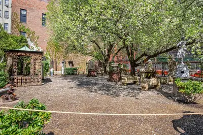 a courtyard with trees and benches in front of a building at Nolita 2br w wd nr SoHo NYC-955 in New York