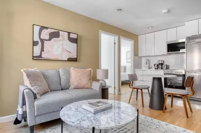 a living room with a couch and a table at Nolita 2br w wd nr SoHo NYC-955 in New York