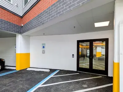 an empty parking lot with a door in a building at 327 Modern 1BR Apt Walk to NJT in Dunellen