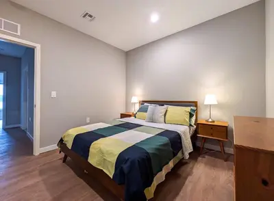 a bedroom with a large bed and a desk at 328 Modern 2BR Apt in Dunellen