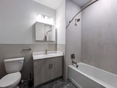 a bathroom with a toilet and a sink and a tub at 328 Modern 2BR Apt in Dunellen