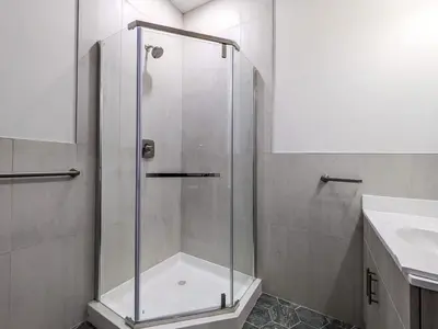 a glass shower in a bathroom with a sink at 328 Modern 2BR Apt in Dunellen