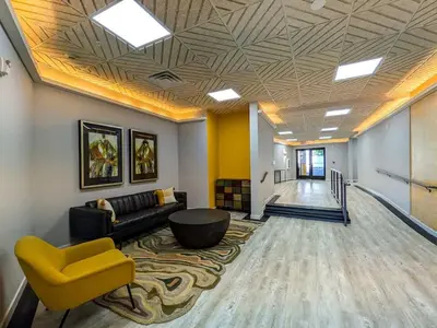 a living room with a couch and a yellow chair at 312 Modern 1BR Apt Walk to NJT in Dunellen