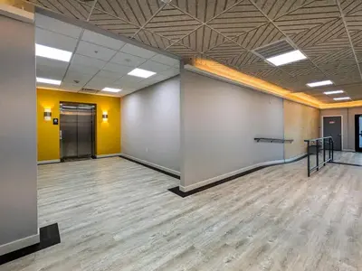 a large room with yellow walls and wooden floors at 212 Modern 1BR Apt Walk to NJTransit in Dunellen