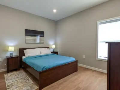 a bedroom with a bed and a large window at 321 Modern 1BR Apt Walk to NJT in Dunellen