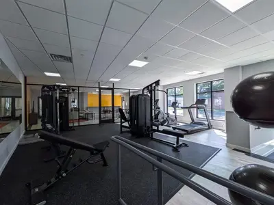 a gym with treadmills and machines in a room at 321 Modern 1BR Apt Walk to NJT in Dunellen