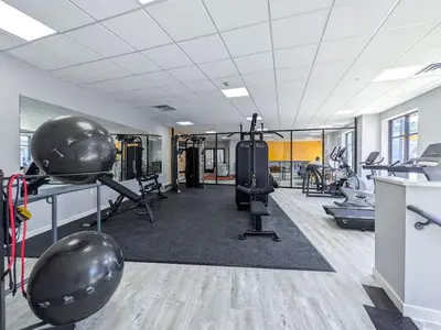 a gym with treadmills and exercise equipment in a room at 321 Modern 1BR Apt Walk to NJT in Dunellen