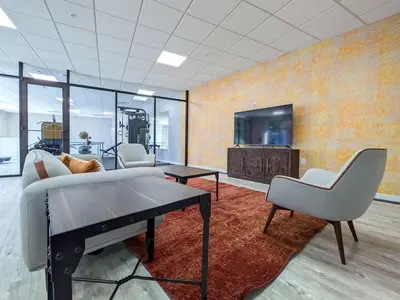 a living room with a couch and a table and a tv at 321 Modern 1BR Apt Walk to NJT in Dunellen