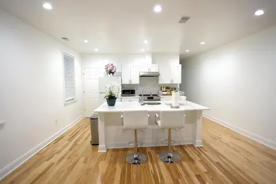 a kitchen with white cabinets and a white counter top at Spacious and Brand New Apartment in Point Breeze - Prime Location in Philadelphia