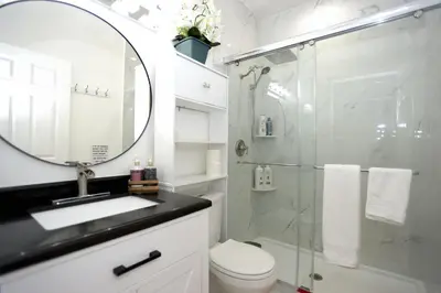 a bathroom with a shower and a toilet and a sink at Spacious and Brand New Apartment in Point Breeze - Prime Location in Philadelphia