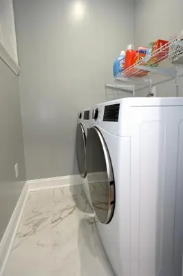 a white washing machine in a white laundry room at Spacious and Brand New Apartment in Point Breeze - Prime Location in Philadelphia