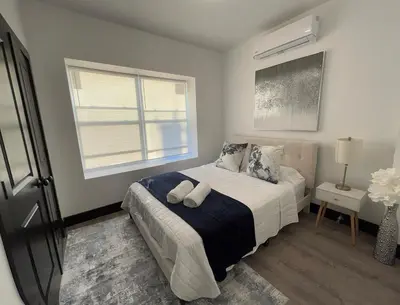 a bedroom with a bed with two pillows and a window at Apartment Few Minutes NYC and Prudential Center in Newark
