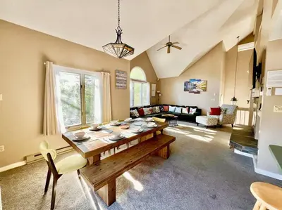 a large living room with a wooden table in it at Lake Harmony 4bdrm Ski pool hot tub lake in Lake Harmony