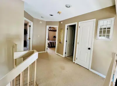 a hallway of a home with a staircase and a door at Lake Harmony 4bdrm Ski pool hot tub lake in Lake Harmony