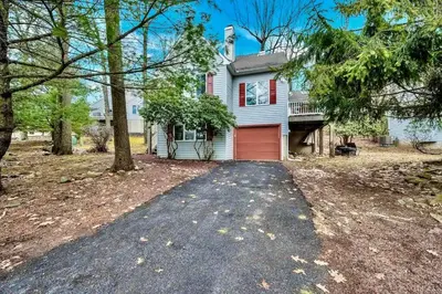 a house with a red garage and a driveway at Lake Harmony 4bdrm Ski pool hot tub lake in Lake Harmony