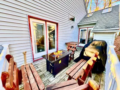 a patio with a bench and a grill and a table at Lake Harmony 4bdrm Ski pool hot tub lake in Lake Harmony