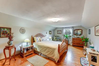 a bedroom with a bed in a room with wooden floors at 1 Mi to Historic District Mtn-View Franklin Home in Otego