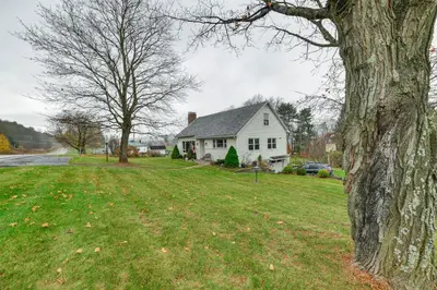 a white house with a tree in the yard at 1 Mi to Historic District Mtn-View Franklin Home in Otego