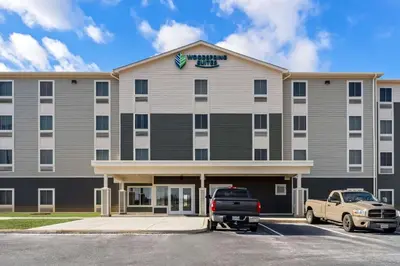 a hotel with a truck parked in a parking lot at WoodSpring Suites Easton Nazareth in Easton