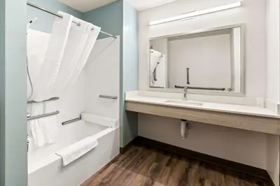 a bathroom with a sink and a mirror at WoodSpring Suites Easton Nazareth in Easton